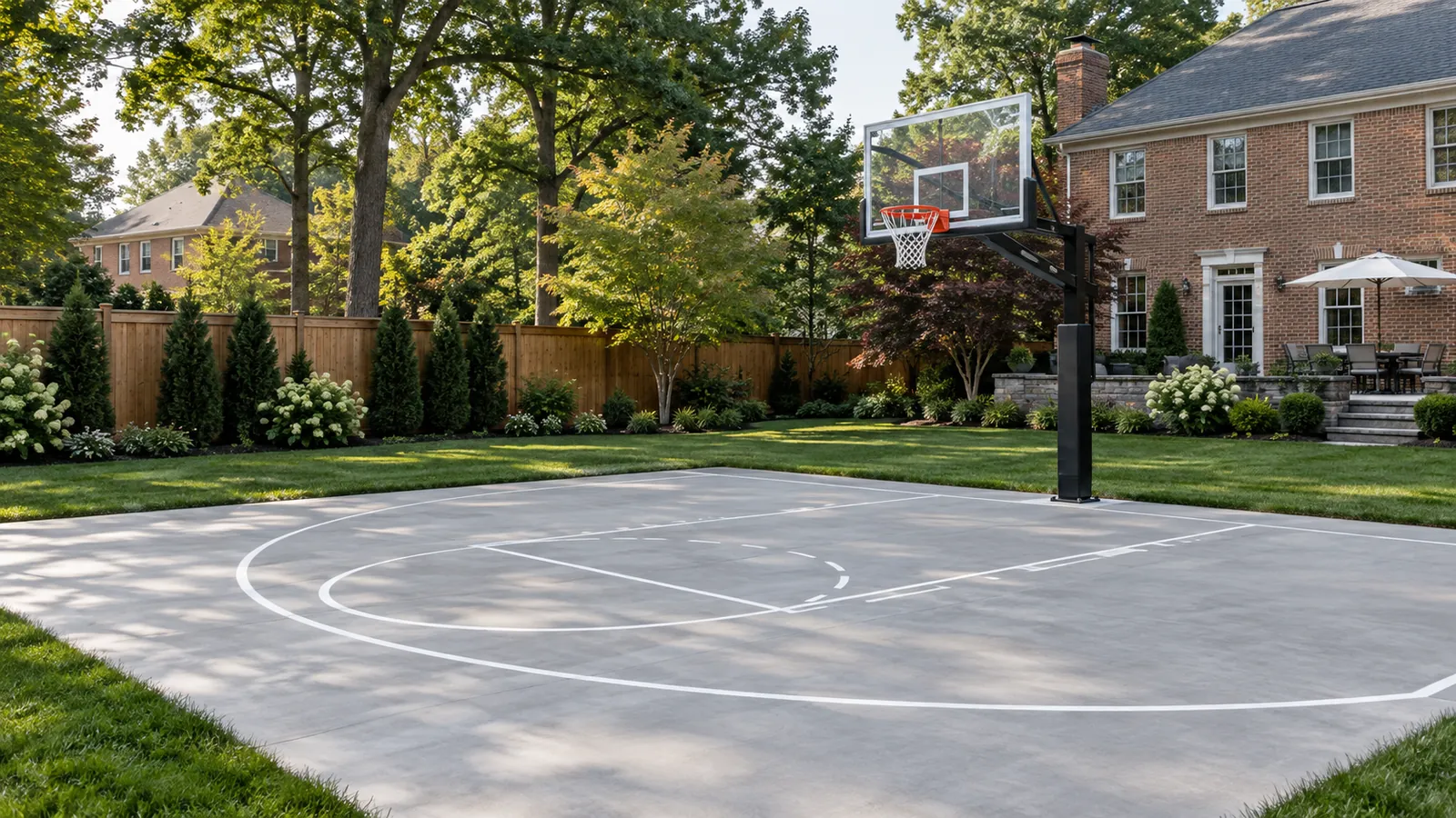 Backyard concrete basketball court with painted key lines and an in-ground hoop beside a brick colonial in Silver Spring, MD, built by SiteDoctorMD